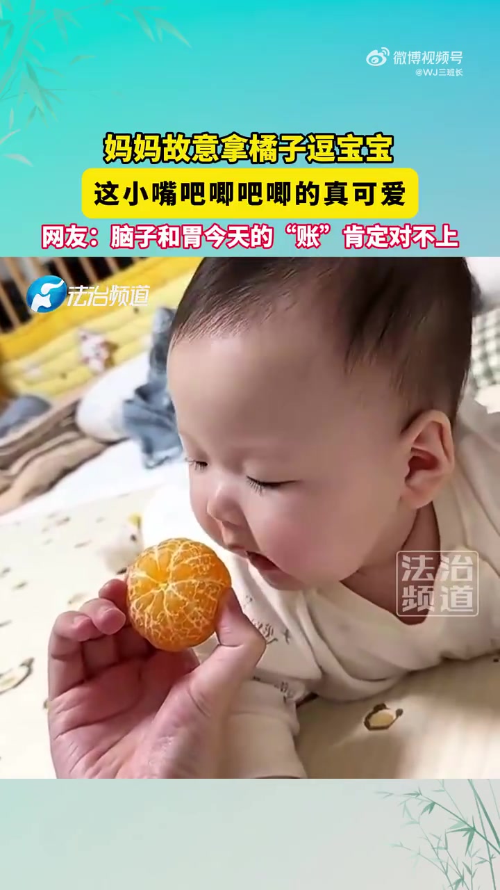 妈妈故意拿橘子逗宝宝，这小嘴吧唧吧唧的真可爱