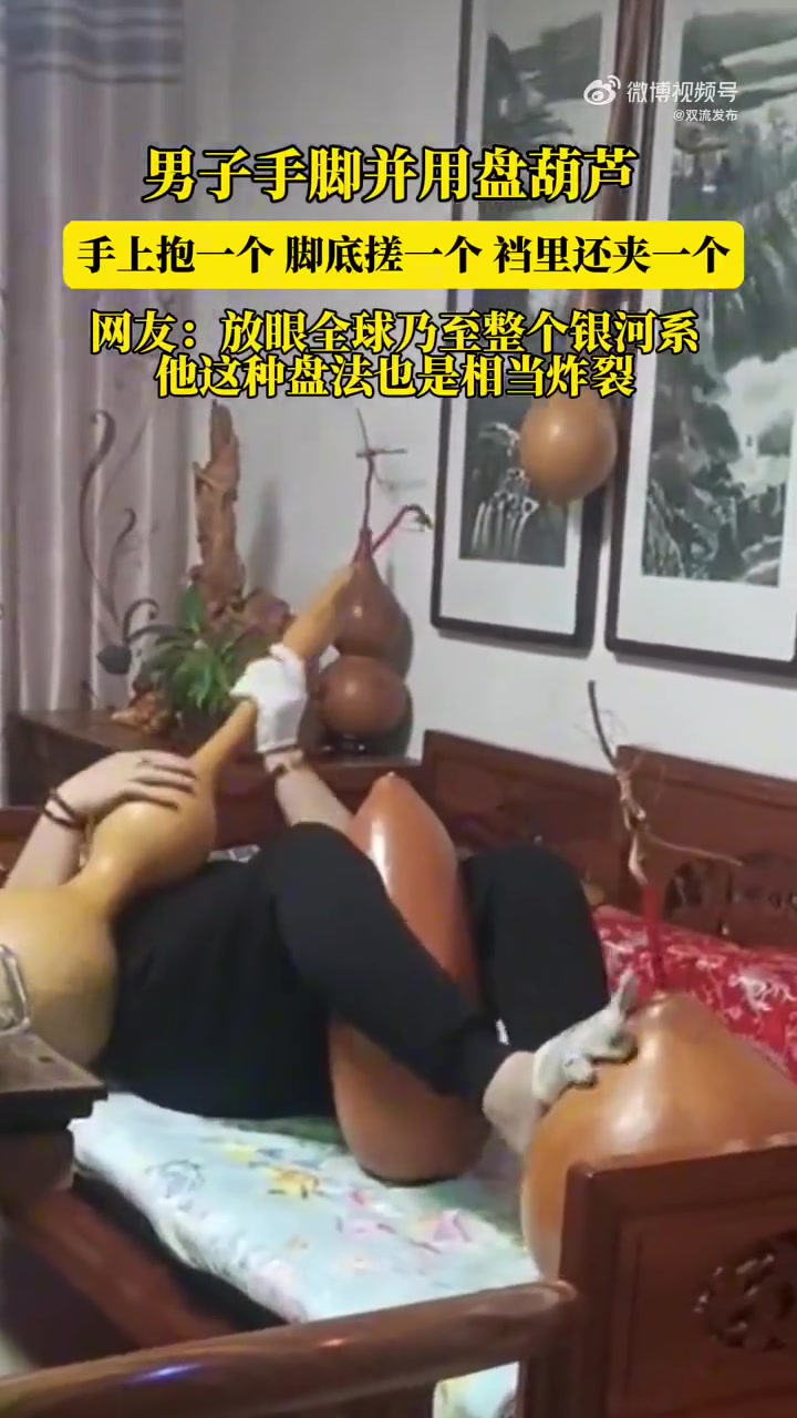 男子手脚并用盘葫芦，手上抱一个，脚底搓一个，裆里还夹一个