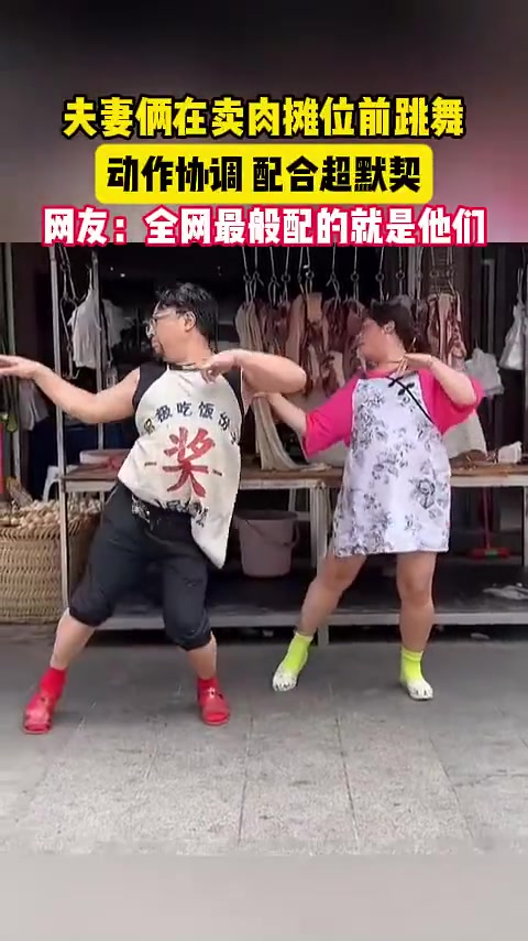 夫妻俩卖肉摊位前起舞，动作协调尽显默契