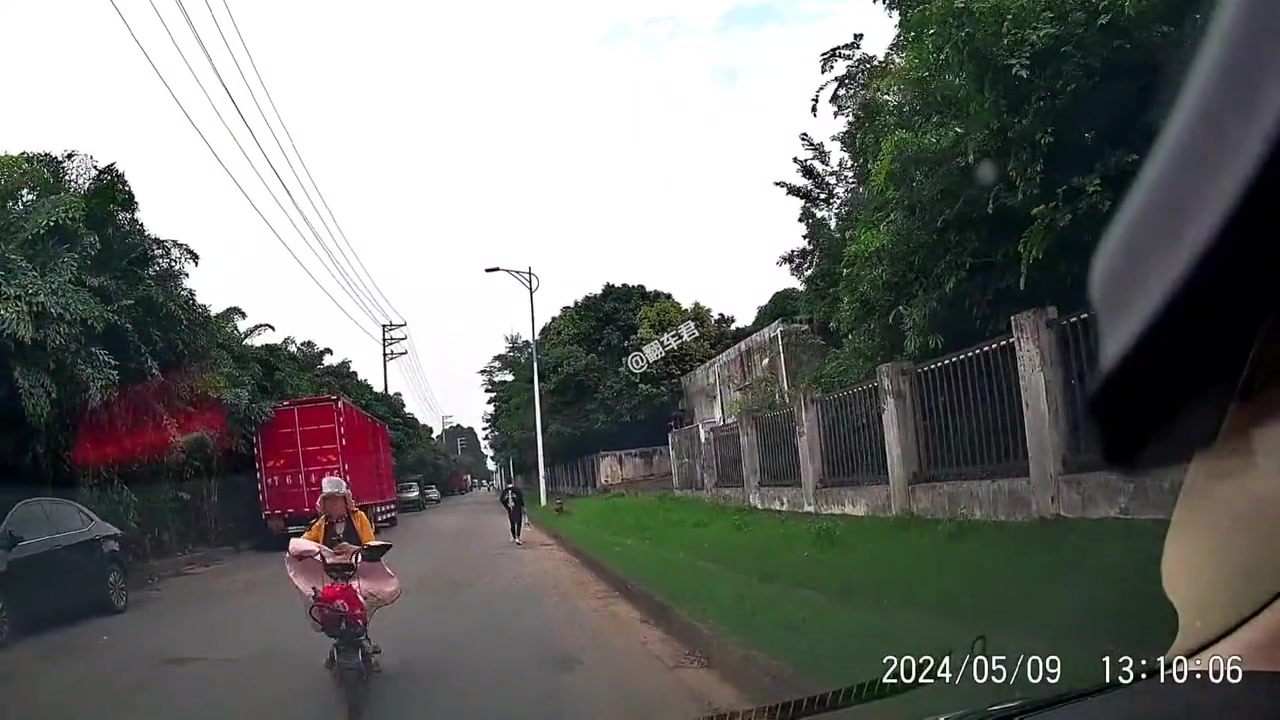 开个电动车还低头看手机