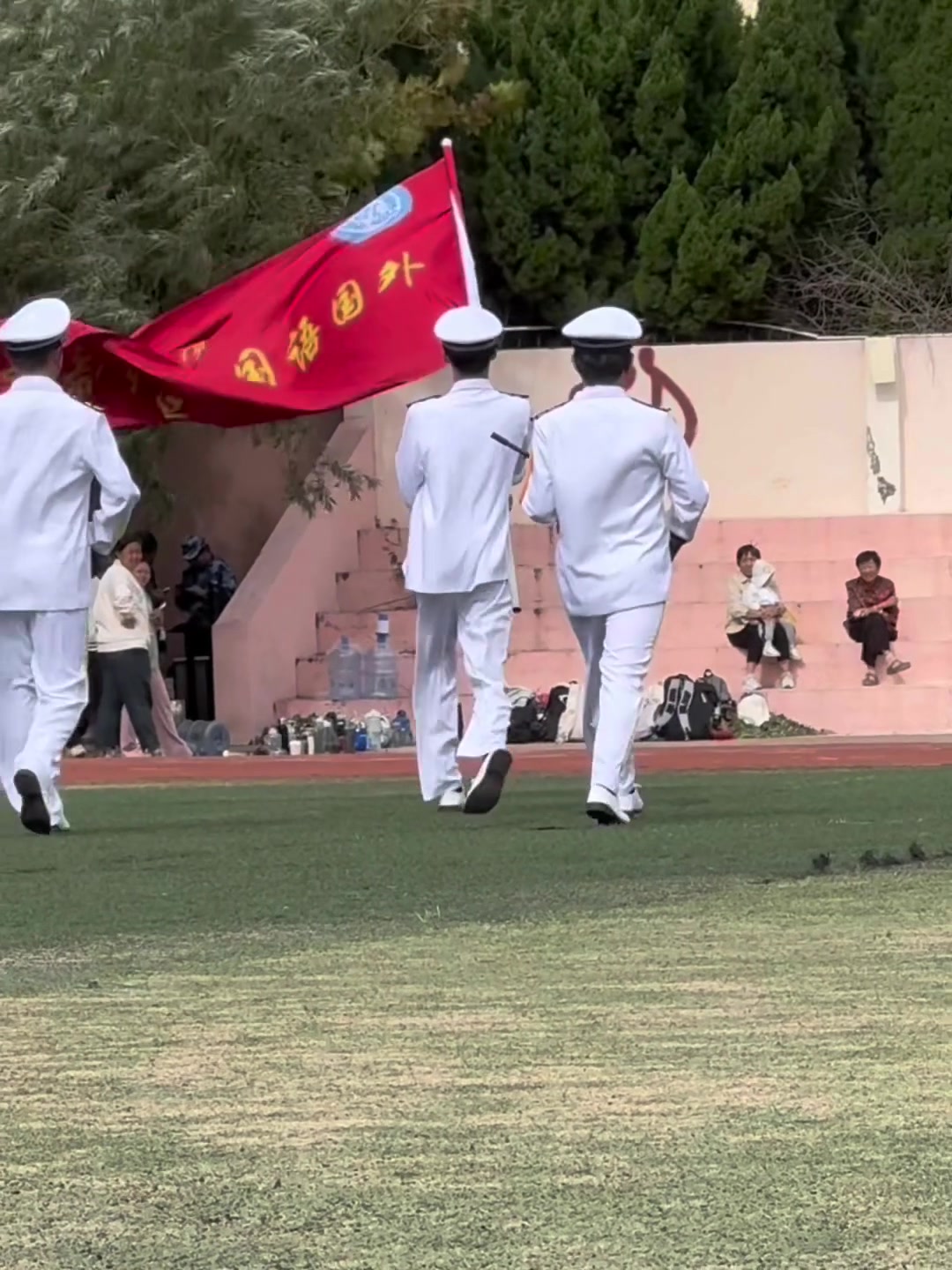 小伙拿旗因风太大被刮倒
