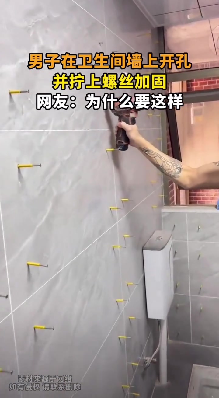男子在卫生间墙上开孔，并拧上螺丝加固