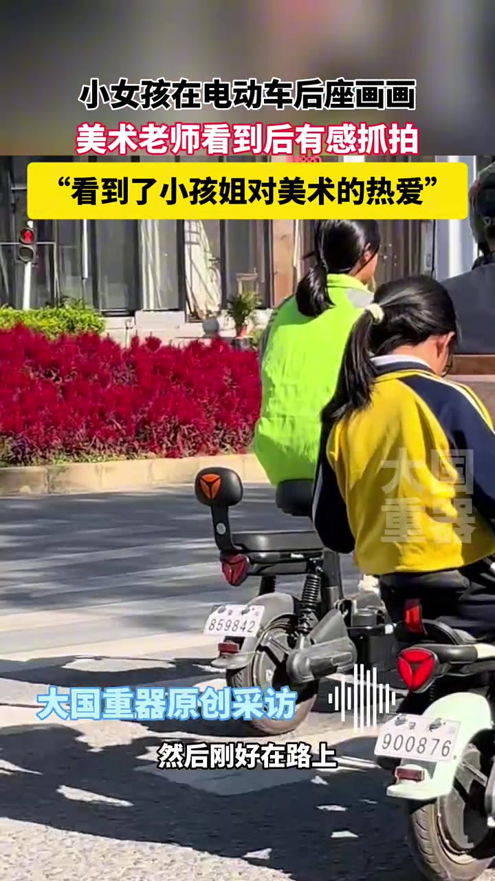 小女孩在电动车后座画画