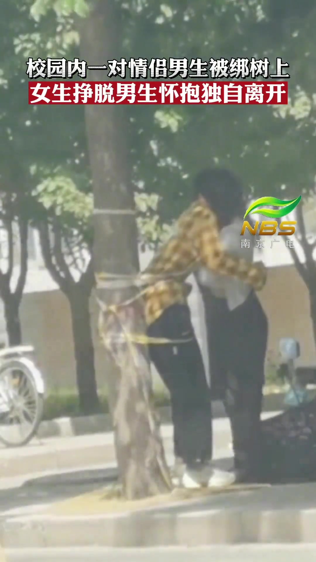 一对情侣男生被绑树上 女生挣脱男生怀抱后离开