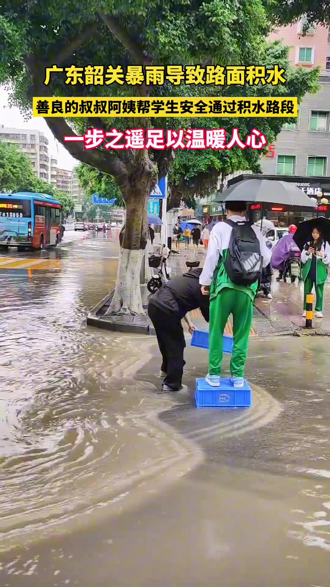 善良的叔叔阿姨帮学生安全通过积水路段#